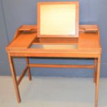 A mid-century teak dressing table with lift up mirror