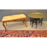 A Middle Eastern brass tray top table with folding base together with a faux marble top coffee table
