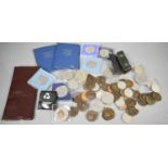 A quantity of commemorative coins, including two Britains First Decimal Coin presentation packs.