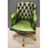 A green button back reproduction swivel chair.