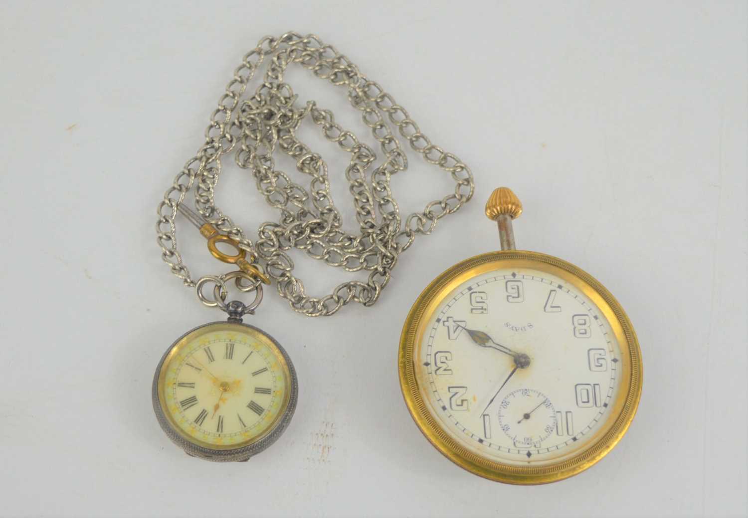 An early 20th century 8 day travel clock made by the Octavia watch company together with a ladies