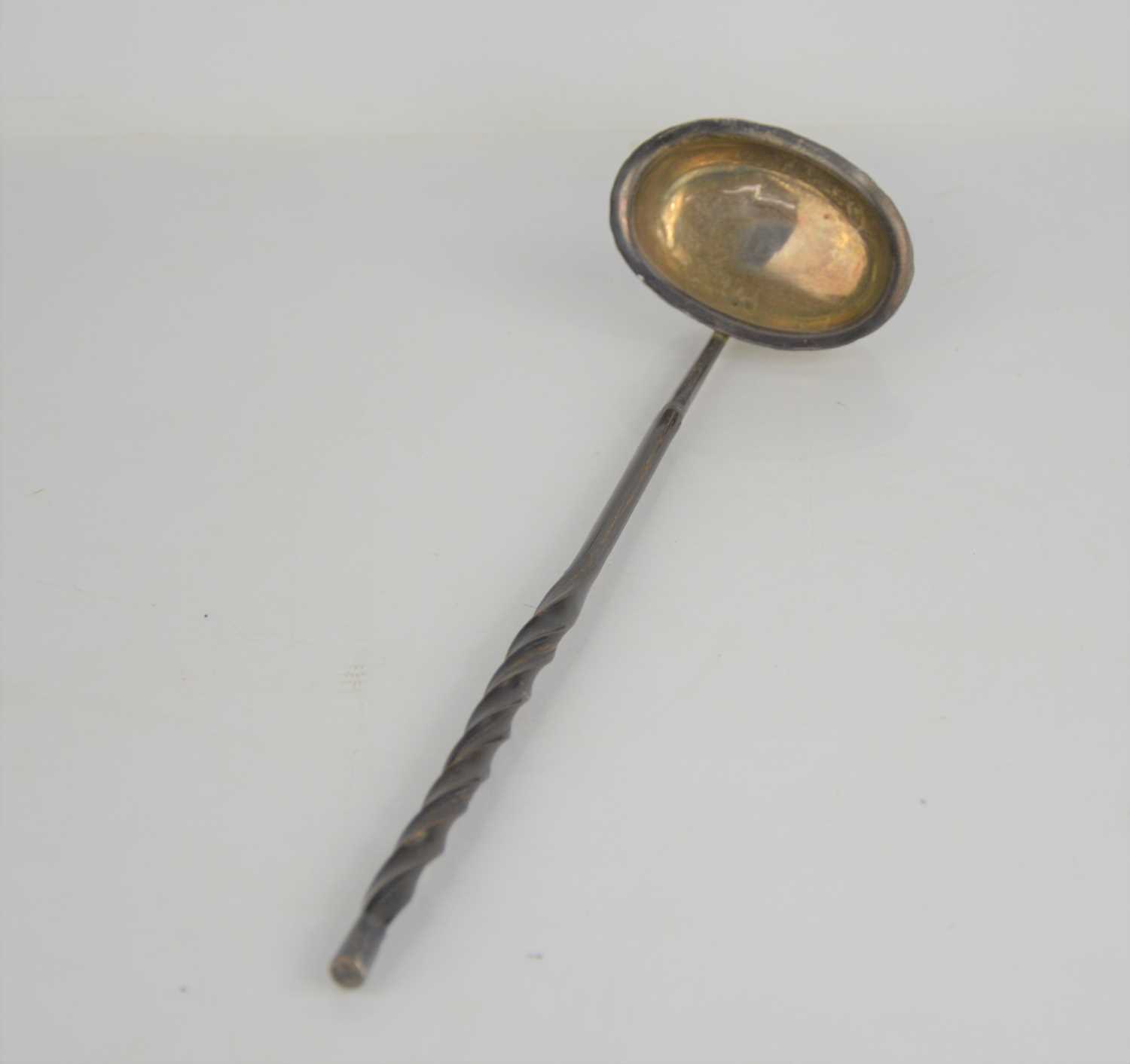 A 19th century white metal toddy ladle baleen handle.