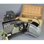 A vintage Guardsman film projector together with a Noris slide projector and a Quarz Zoom cine