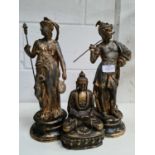 A pair of antique metal figurines in the form of a Roman lady and gentleman together with a brass