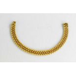 An 18ct gold bracelet, composed of interlocking beads, the clasp having a safety clip, 20.62g.