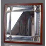A white metal Italian mirror, with hammered panels and embossed decoration, Fl Ag 3g 1137, 55 by