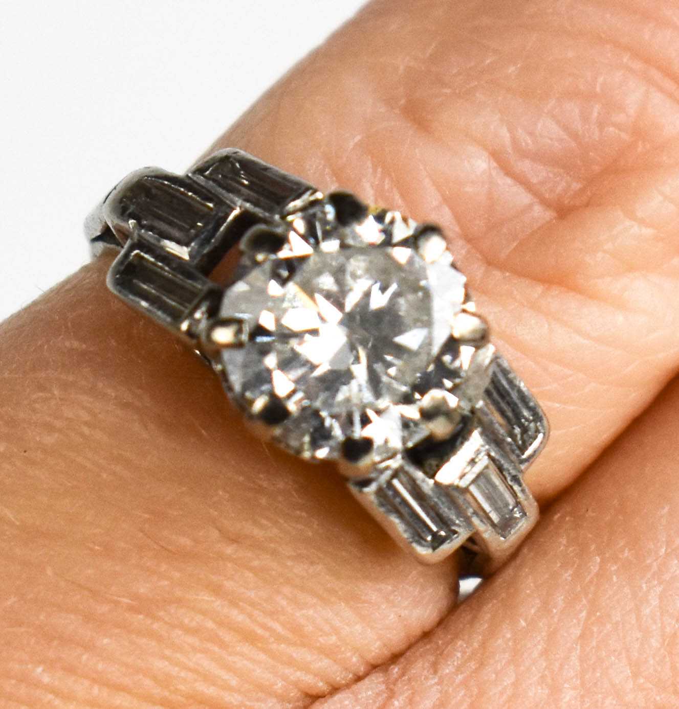 An Art Deco platinum and diamond ring, approximately 2.5cts diamond total, the brilliant cut diamond