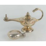 An Anglo-Indian silver table cigar lighter, modelled as a Roman lamp, with fluted finial, serpent
