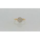 An 18ct gold and diamond daisy head ring, the central stone of approximately 0.06ct surrounded by