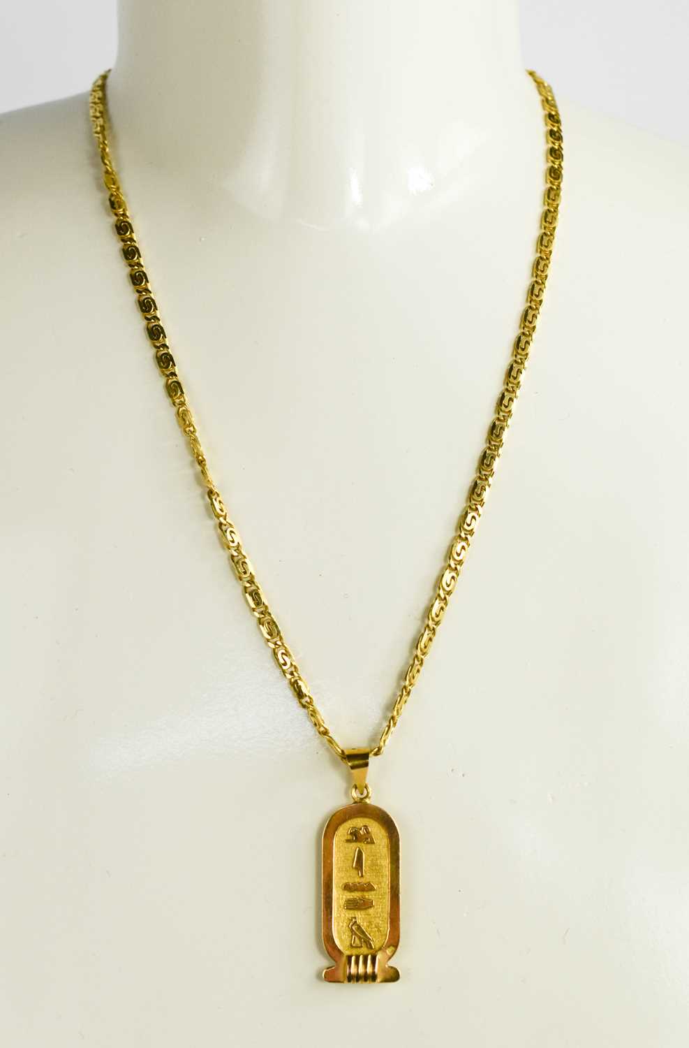 An 18ct gold pendant necklace, the necklace composed of chain links, and the pendant having Egyptian