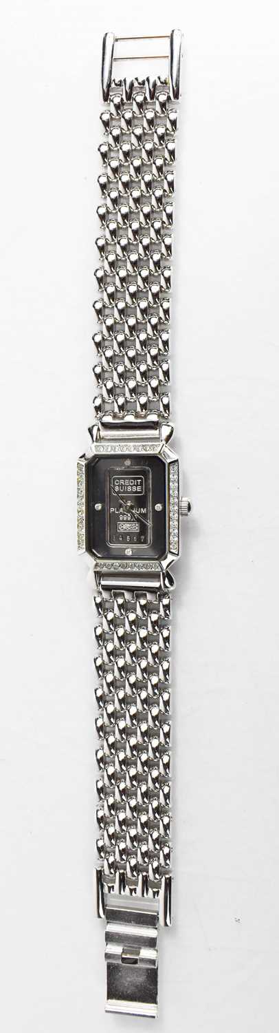 A ladies wristwatch, inset with a 999.5 Credit Suisse 1 Gram Fine Platinum Ingot, and having a chain