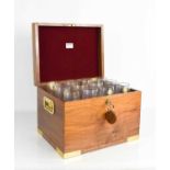 A campaign style hand made travelling champagne flute box, containing twelve cut glass flutes,