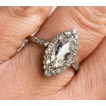 A platinum and diamond ring, the central marquise cut diamond bordered by diamonds, and to the