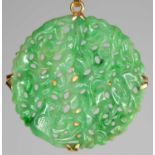 A jade and possibly gold - unmarked - pendant of circular pierced disc form decorated with birds and