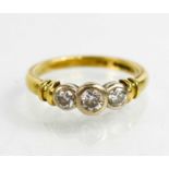 An 18ct gold and diamond ring, the three brilliant cut diamonds totalling approximately 0.40cts, 3.