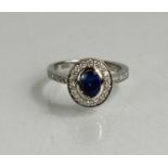 An 18ct white gold, sapphire and diamond halo ring, size M, 5.4g.