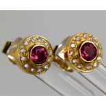 A pair of 18ct gold, ruby and diamond cluster earrings.