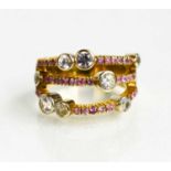 A 14ct gold, diamond and pink sapphire set ring, of contemporary design, the triple band