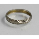 A platinum wedding band, with Modernist circles and textured finish, size M/N, 3.14g.