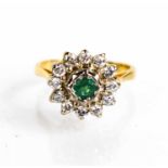 An 18ct gold, diamond and emerald flowerhead ring, 3.88g.