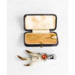 A gold and pearl pin, in the original box, together with a Scottish grouse foot brooch.