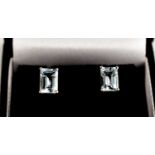 A pair of 18ct white gold and emerald cut aquamarine earrings, approximately 1ct each.