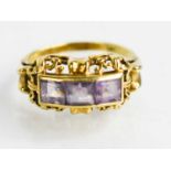 A 14ct gold and amethyst three stone ring in decorative setting, size Q, 4.43g.