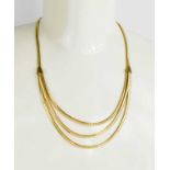 A 14ct gold necklace, the single strand forming three strands composed of interlocking segments,