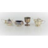 A group of silver table items comprising a salt and mustard pot, of early Art Deco octagonal design,