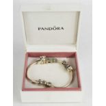 A Pandora bracelet, with five charms, with the original box.