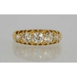 An 18ct gold (unmarked) five stone diamond ring, the stones of graduated size, the largest diamond