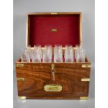 A 20th century handmade mahogany brass clad campaign style decanter box comprising twelve cut