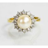 An 18ct gold, pearl, diamond and platinum ring, the large central cultured pearl bordered by