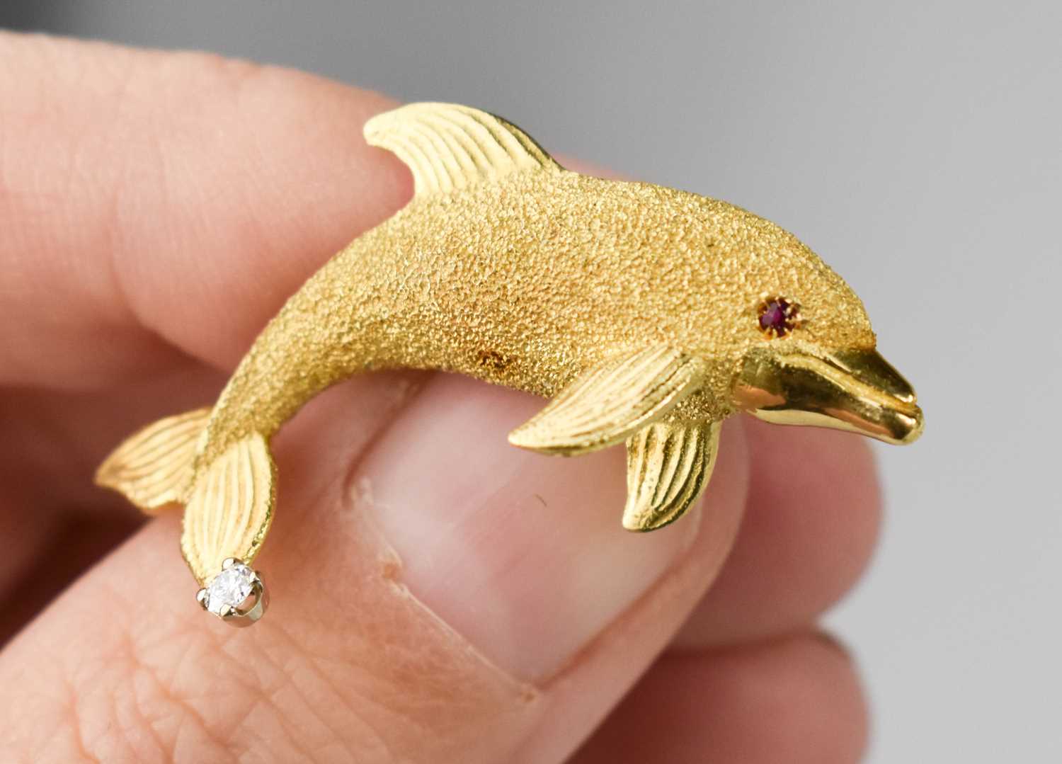 An 18ct gold, ruby and diamond brooch, with a textured body, ruby eye and diamond to the tail, 3.7g. - Bild 2 aus 3