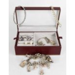 A jewellery box containing a 9ct white gold twist form bangle 4.2g, a silver charm bracelet, a