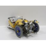 Large Meccano constructed model of a three-wheeled sports car in yellow and silver, 47cm long