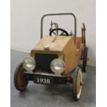 Child's ride-in pedal car in the style of an old fire engine with licence registration "FD1938" with