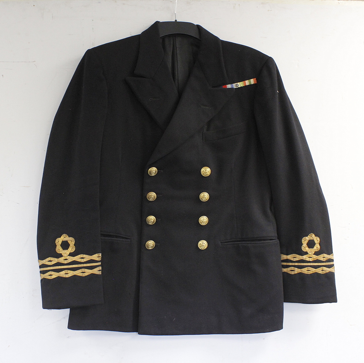 British Royal Navy dress uniform jacket having Gieves Ltd label "L/5/43 23/13419 D Macdonald A1",