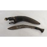 Two Antique Nepalese Kukris, one in curved leather scabbard with two smaller blades, inlaid