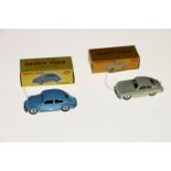 Two Dinky Toys diecast model vehicles; 181 Volkswagen saloon car with light blue body and spun