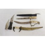 Group of four daggers to include Arabian Jambya dagger in white metal scabbard and Cretan dagger