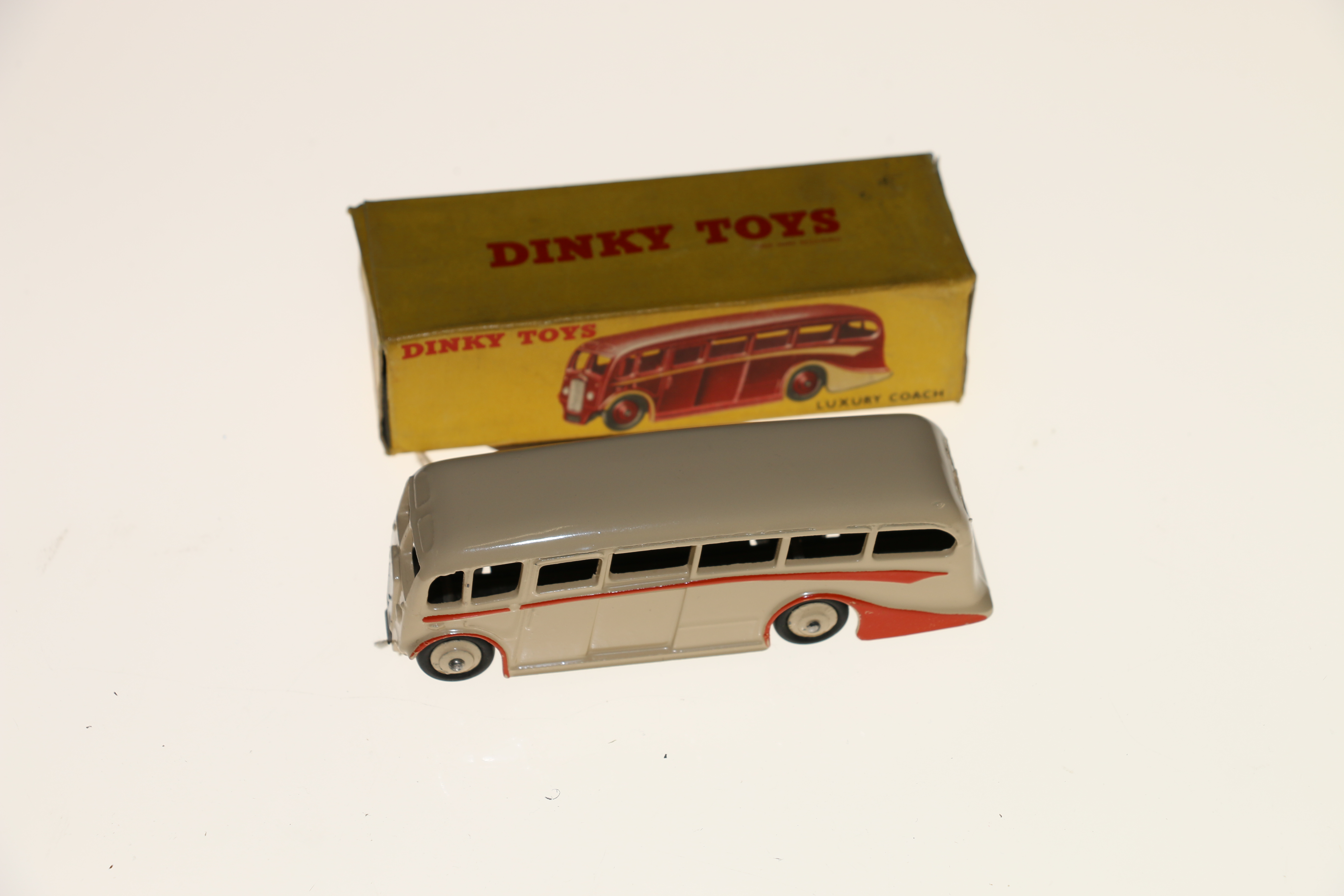 Dinky Toys diecast public transport vehicle 281 Luxury Coach with cream body and hubs and orange