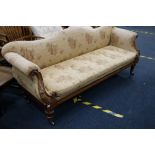 Victorian mahogany framed sofa, with carved recurved arms raised on turned supports capped by