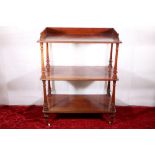 Victorian mahogany three tier buffet table with gallery back, raised on turn supports and brass