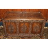 Antique oak hinge top blanket box chest with carved fielded triple panel front raised on straight