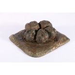 An unusual bronze casting of five lumps of camel dung, 19cm x 17cm