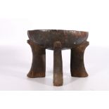 Ethiopian ironwood Jima stool with dished top, on four carved supports, possibly early 20th Century,