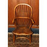 Antique elm Windsor style arm chair with spindle back above saddled seat raised on turned supports