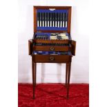 Walker and Hall comprehensive two drawer canteen of cutlery in mahogany case raised on tapering
