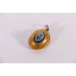 Victorian unhallmarked yellow metal mourning pendant of oval from with blue enamelled cabochon to
